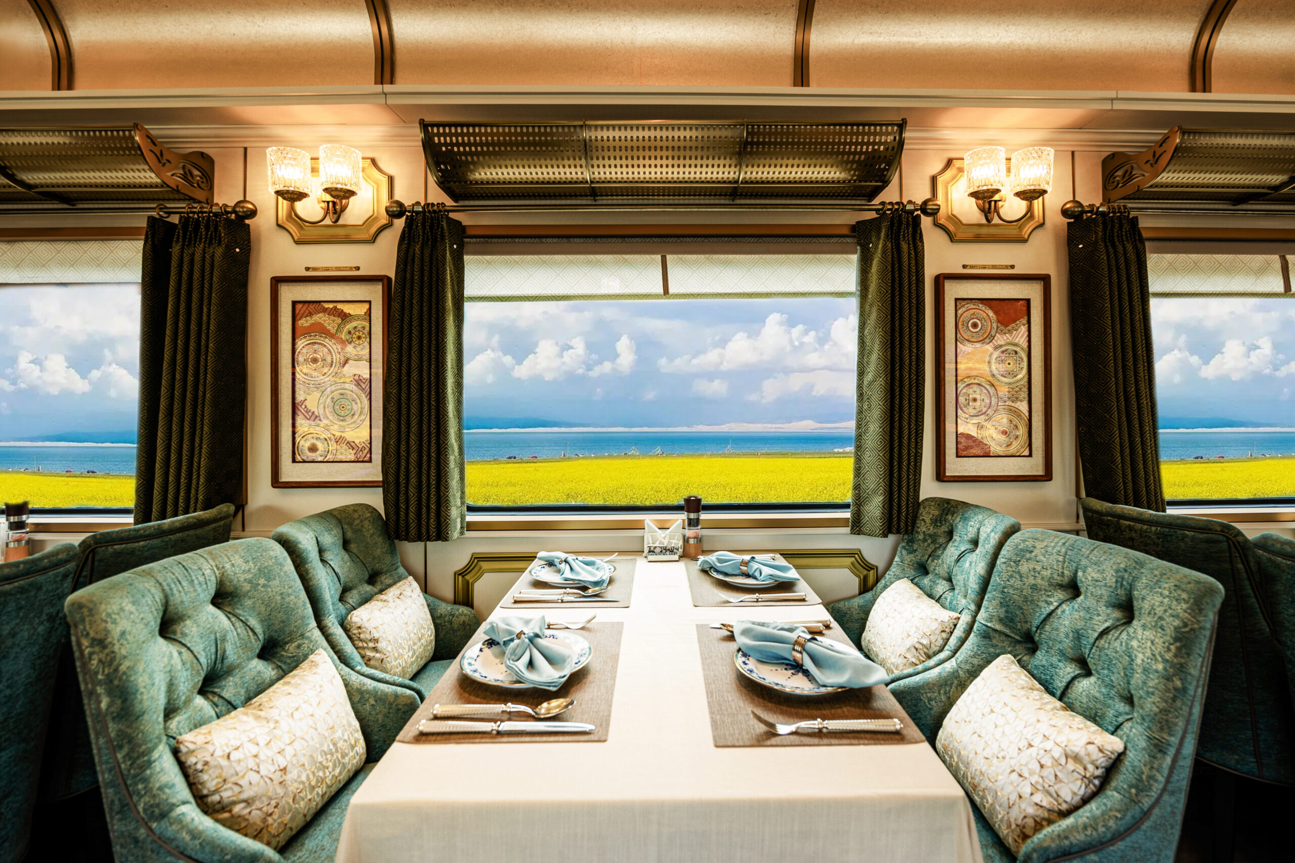 White dining table with velvet mint chairs on the  Golden Eagle Silk Road Express train. 