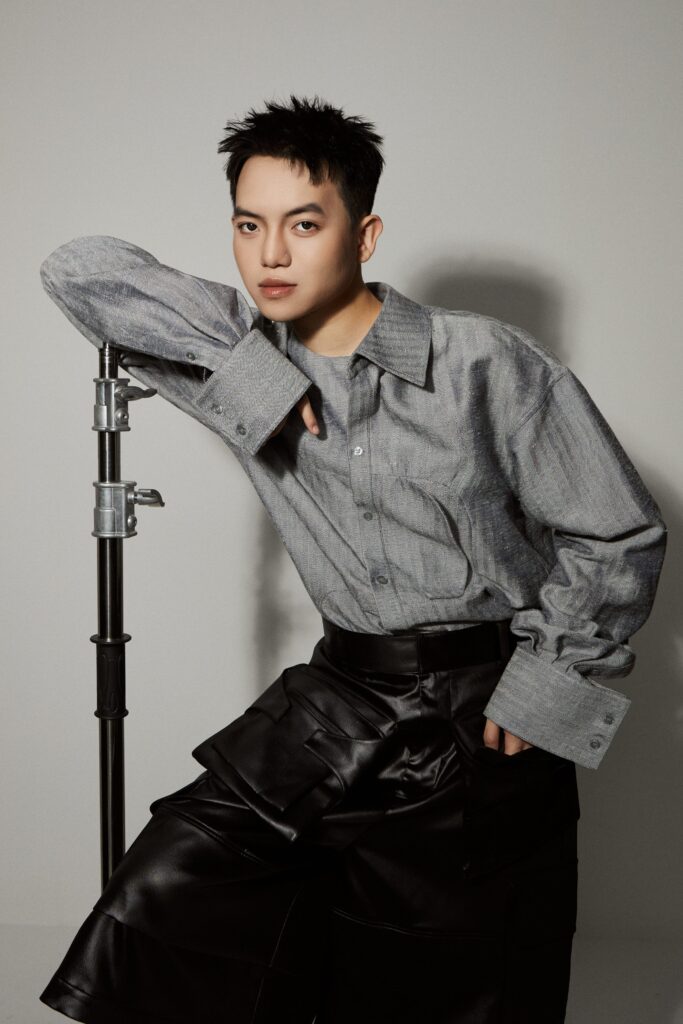 Creative director Phan Hang Doang wearing a grey button down shirt and leather pants.